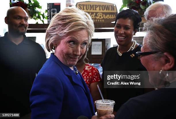 Democratic presidential candidate Hillary Clinton talks to DC Councilmember Anita Bonds as DC Mayor Muriel Bowser looks on during a visit to Uprising...