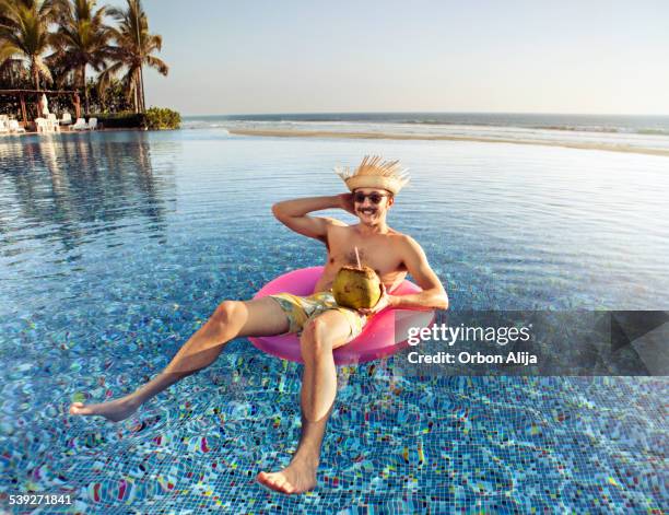 touristen in den swimmingpool - aufblasbarer gegenstand stock-fotos und bilder