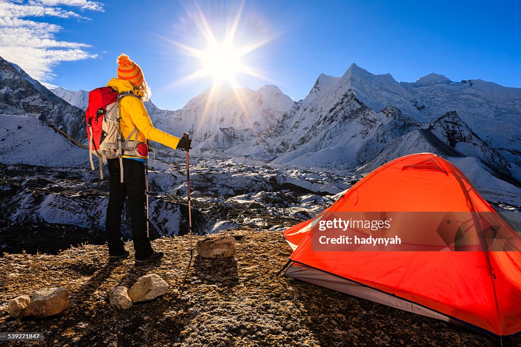 Woman is watching sunrise in Himalayas, Mount Everest National Park