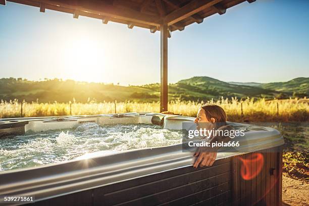 woman in whirlpool hot tub during spa treatment - hot tub stock pictures, royalty-free photos & images