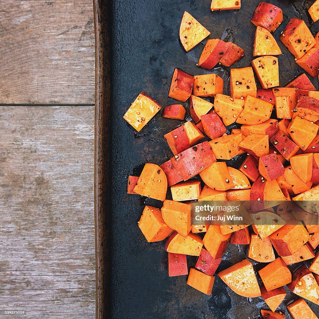 Cubed sweet potatoes on a roasting pan