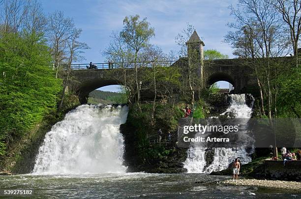 Tourists at the river Ambleve and the waterfalls of Coo, Stavelot, Belgian Ardennes, Belgium.