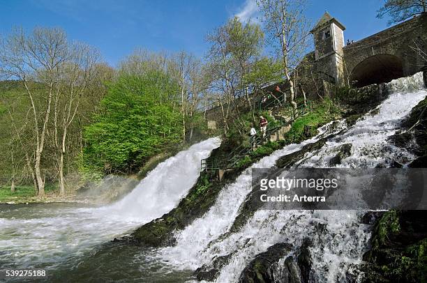 Tourists at the river Ambleve and the waterfalls of Coo, Stavelot, Belgian Ardennes, Belgium.