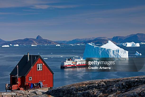 Cruise ship among icebergs in the Uummannaq fjord, North-Greenland, Greenland.