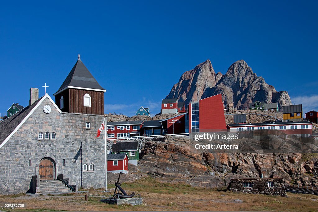 Uummannaq village with colourful houses and church in front of Heart Mountain