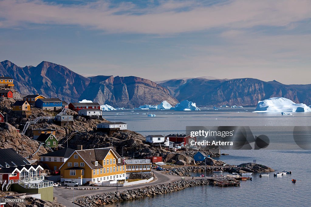Uummannaq village with colourful houses and icebergs in the fjord