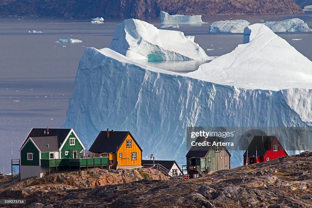 Uummannaq village with colourful houses and icebergs in the fjord