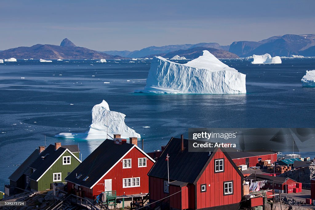 Uummannaq village with colourful houses and icebergs in the fjord