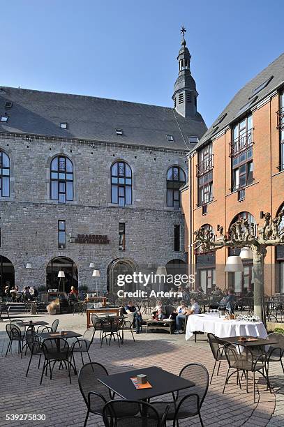 Tourists on terrace of the hotel Quartier Latin, established in an authentic, 18th century Jesuit church at Marche-en-Famenne, Ardennes, Belgium.