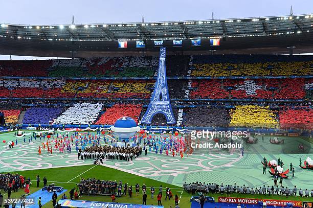 Dancers are seen as Dj David Guetta performs during the opening ceremony of Euro 2016 before group A football match between France and Romania, at...