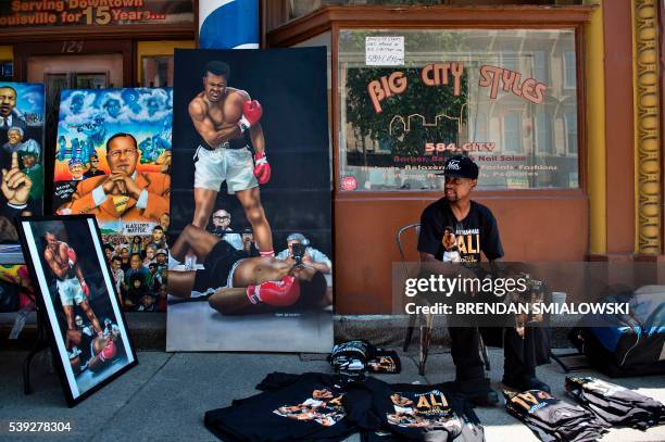 Vendor sells Muhammad Ali memorabilia while people attend a memorial service for the boxing legend at the KFC Yum! Center nearby on June 10, 2016 in...
