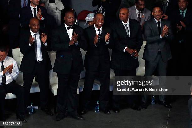 Pallbearers including Will Smith at right, Mike Tyson at left, and Lennox Lewis, second from left, look on during a memorial service for boxing...