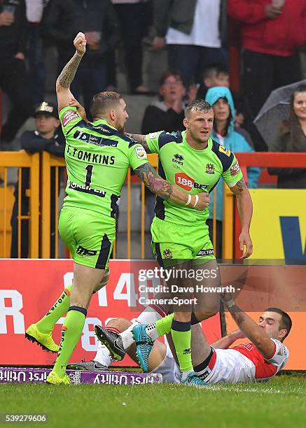 Sam Tomkins and Dominic Manfredi of Wigan Warriors celebrate their first try during the First Utility Super League Round 18 match between Hull...