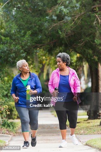 Two senior black women exercising together Two senior black women exercising together