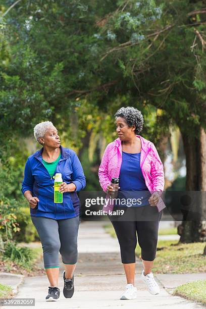 two senior black women exercising together - friends serious stock pictures, royalty-free photos & images