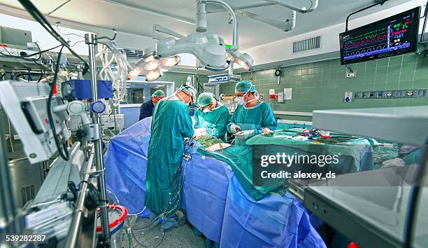 surgeons in operating room - operation stock pictures, royalty-free photos & images