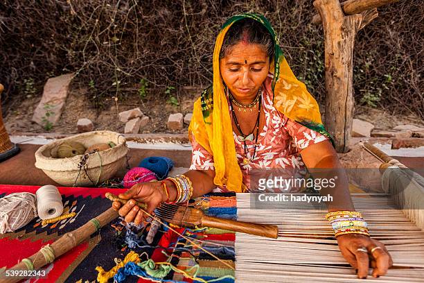 indian woman weaving textiles (durry) in rajasthan - rajasthani women stock pictures, royalty-free photos & images