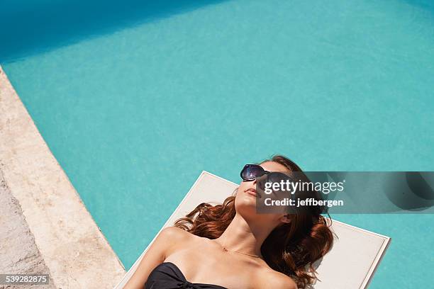 working on her tan - hyatt hotels corp hotel ahead of earnings figures stockfoto's en -beelden