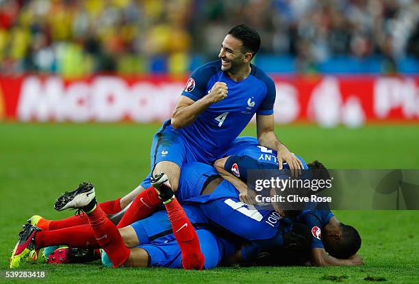 Adil Rami and French players celebrate their team's second goal scored by Dimitri Payet during the UEFA Euro 2016 Group A match between France and...