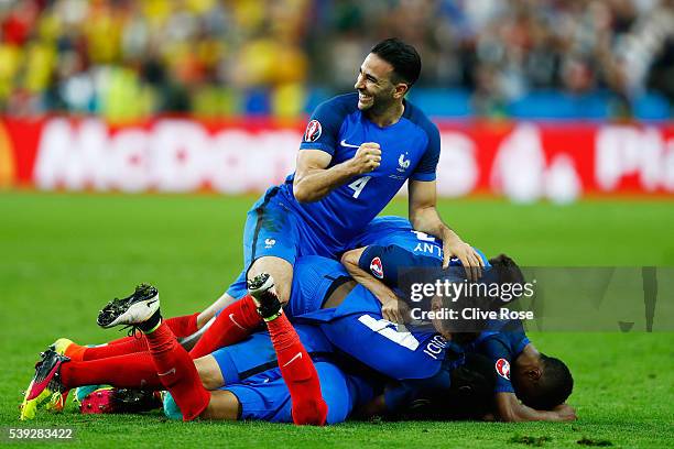 Adil Rami and French players celebrate their team's second goal scored by Dimitri Payet during the UEFA Euro 2016 Group A match between France and...