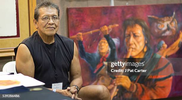 Garry Montgomery, a member of the Seminole tribe, displays his paintings at the Red Earth Native American Festival, Friday, June 10, 2016 in Oklahoma...