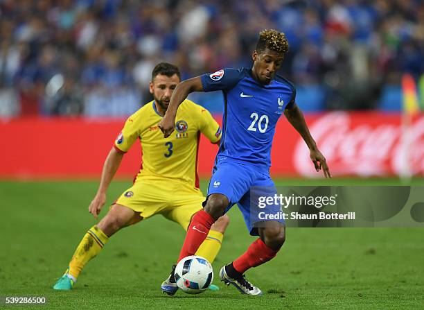 Kingsley Coman of France controls the ball under pressure of Razvan Rat of Romania during the UEFA Euro 2016 Group A match between France and Romania...