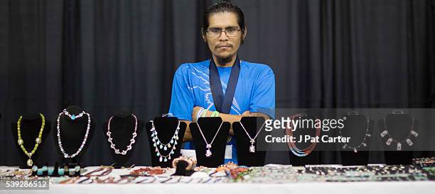 Clifton Aguilar of the Kewa Pueblo in New Mexico, displays his hand made jewelry at the Red Earth Native American Festival, Friday, June 10, 2016 in...
