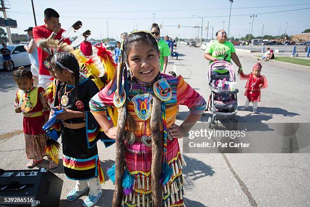 Young Cheyenne/ Arapaho dancers wait for the start of the Red Earth Native American Festival parade, Friday, June 10, 2016 in Oklahoma City.