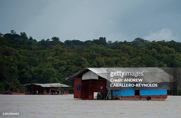 The floating living quarters for gold miners is seen near a mining barge on the Mazaruni river near the town of Bartica, Guyana on June 6, 2016....