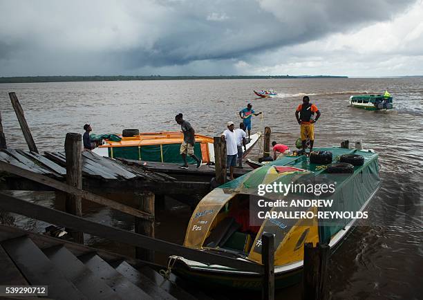 River taxis wait for customers at the dock in the town of Bartica, Guyana on June 6, 2016. Bartica is a town at the confluence of two major rivers...