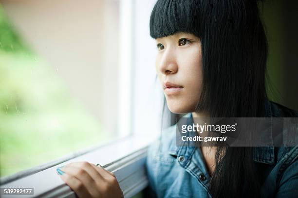 クローズアップの近くにウィンドウを吸うティーンエイジャーの女の子。 - 若い カワイイ 女の子 日本人 ストックフォトと画像