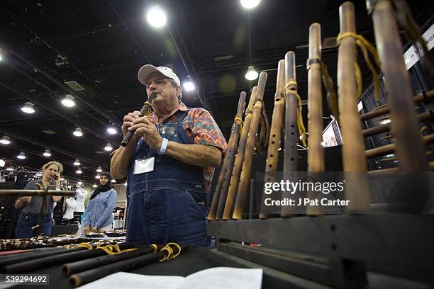 Ronald Willison plays one of the flutes he makes at the Red Earth Native American Festival, Friday, June 10, 2016 in Oklahoma City.