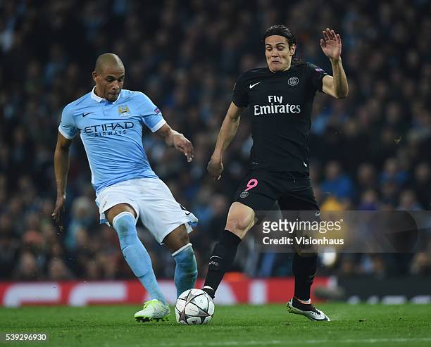 Edinson Cavani of Paris Saint-Germain is tackled by Fernando of Manchester City during the UEFA Champions League Quarter Final Second Leg match...