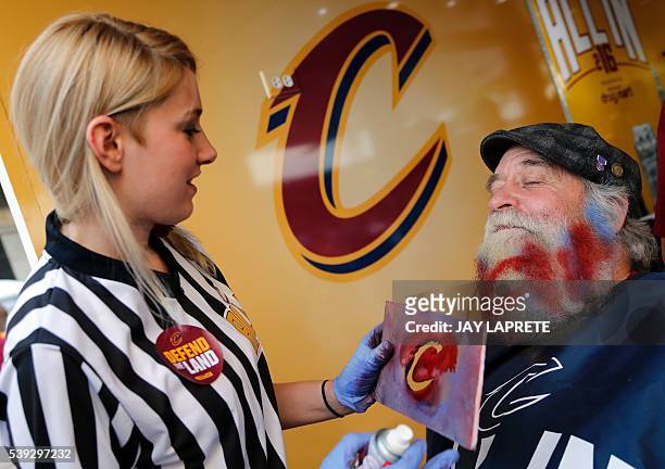 Tom Dewolf of Mentor has a logo painted on his beard before the start of Game 4 of the NBA Finals between the Cleveland Cavaliers and the Golden...