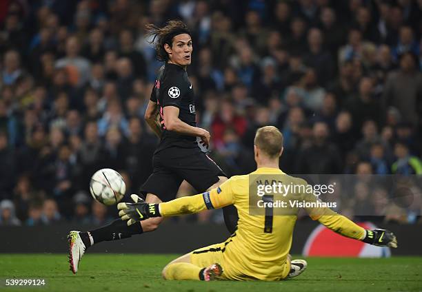 Edinson Cavani of Paris Saint-Germain tries to slip the ball past Joe Hart of Manchester City during the UEFA Champions League Quarter Final Second...