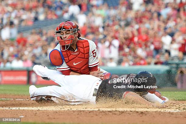 Ben Revere of the Washington Nationals beats the tag by Carlos Ruiz of the Philadelphia Phillies on a Jayson Werth triple in the third inning during...