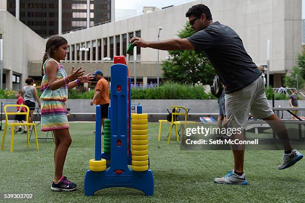Omar Samalot places a disc while playing connect four with his daughter, Sofia Samalot at Skyline Park in Denver, Colorado on June 10, 2016. Denver...