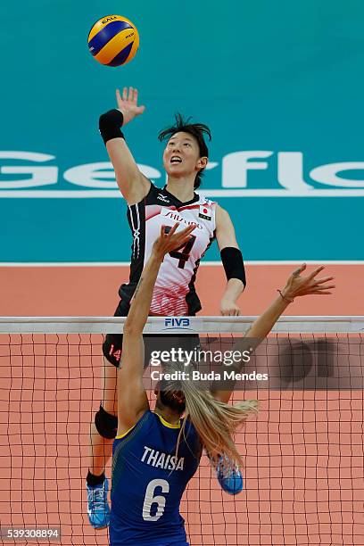 Yukiko Ebata of Japan spikes the ball as Thaisa Menezes of Brazil defends during the match between Brazil and Japan on day 2 the FIVB Volleyball...