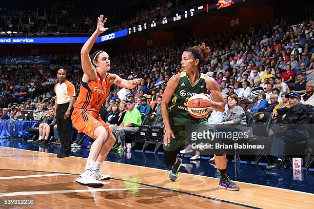 Alysha Clark of the Seattle Storm handles the ball against Kelly Faris of the Connecticut Sun on June 10, 2016 at Mohegan Sun Arena in Uncasville,...