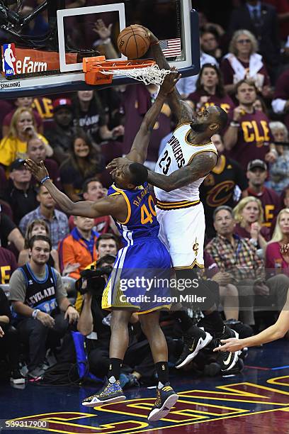 LeBron James of the Cleveland Cavaliers dunks the ball against Harrison Barnes of the Golden State Warriors during the second half in Game 4 of the...