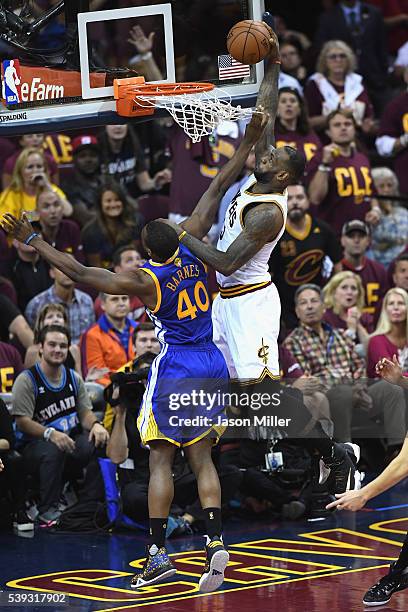 LeBron James of the Cleveland Cavaliers dunks the ball against Harrison Barnes of the Golden State Warriors during the second half in Game 4 of the...