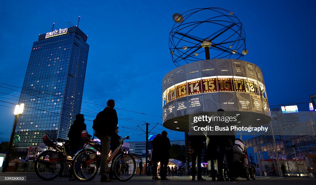 Berlin Alexanderplatz night Scene, with the Weltzeituhr (World Time Clock), built in 1969, and the Park Inn Hotel highrise in the background