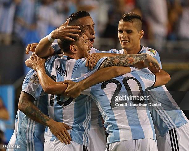 Lionel Messi of Argentina is hugged by teammates including Ever Banega , Nicolas Gaitan and Gabriel Mercado after scoring a goal on a penalty kick...