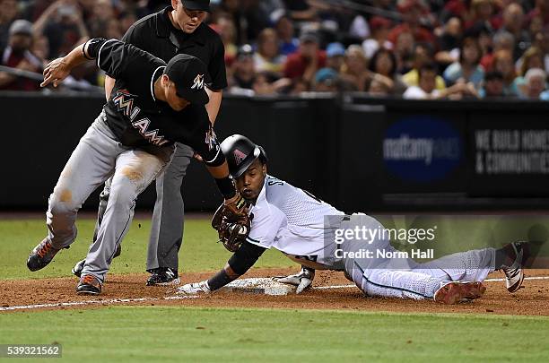 Jean Segura of the Arizona Diamondbacks safely steals third base just ahead of the tag by Martin Prado of the Miami Marlins during the sixth inning...