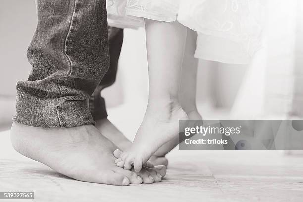 father dancing with his daughter - baby pants with feet stock pictures, royalty-free photos & images