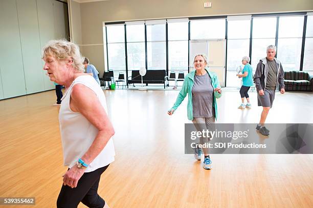 active seniors particpate in dancing class - line dancing stock pictures, royalty-free photos & images