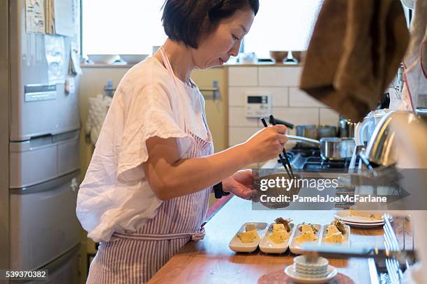 japanese woman preparing dinner in home kitchen, kyoto, japan - japanese food stock pictures, royalty-free photos & images