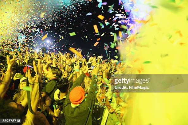 Confetti flies over festival goers as Tame Impala perform onstage at Which Stage during Day 2 of the 2016 Bonnaroo Arts And Music Festival on June...