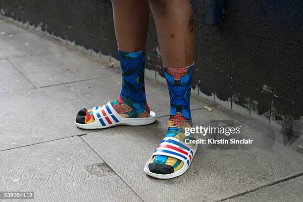 Customised jewellery and Accessories designer for Boy London Peter Illamadi wears Adidas Pool slides and Lego for Topman socks on day 1 of London...