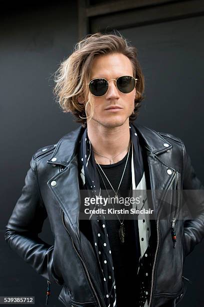 Bassist from McFly Dougie Poynter wears Ray Ban sunglasses, Sandro T shirt, Rockins scarf and a BLK DNM jacket on day 1 of London Collections: Men on...